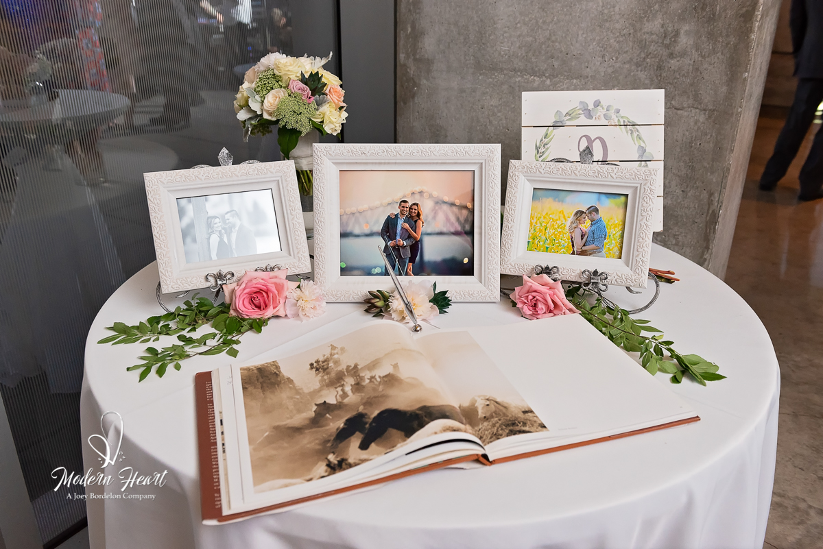 memorabilia table with photos and guest book at Louisiana wedding