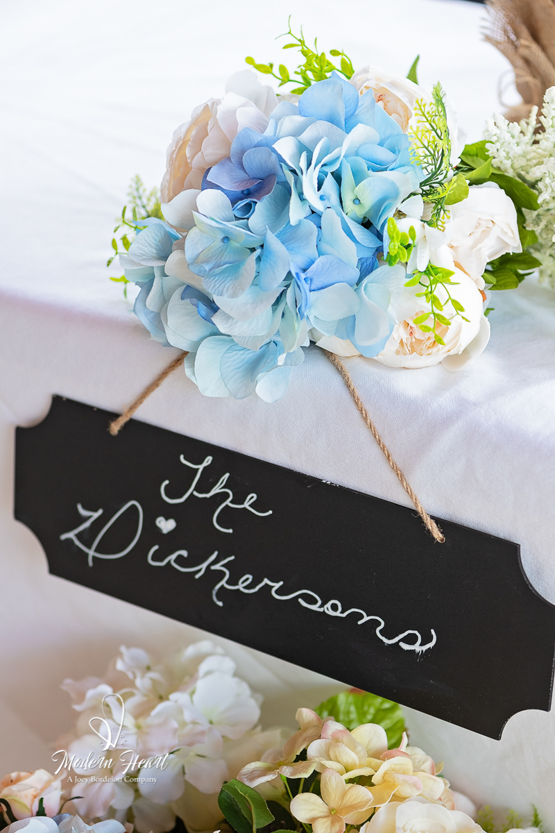up-close shot of name plaque with blue flowers at Louisiana Wedding